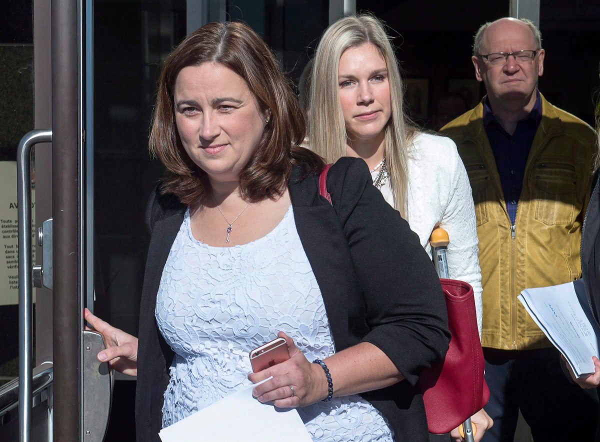 Nadine Larche, left, wife of Const. Doug Larche and Rachael Ross, wife of Const. Dave Ross, head from the Law Courts in Moncton, N.B. on Friday, Sept. 29, 2017. The RCMP has been convicted of violating the Labour Code for failing to provide its members with use-of-force equipment and training in connection with the 2014 New Brunswick shooting rampage that left three Mounties dead and two others injured.
