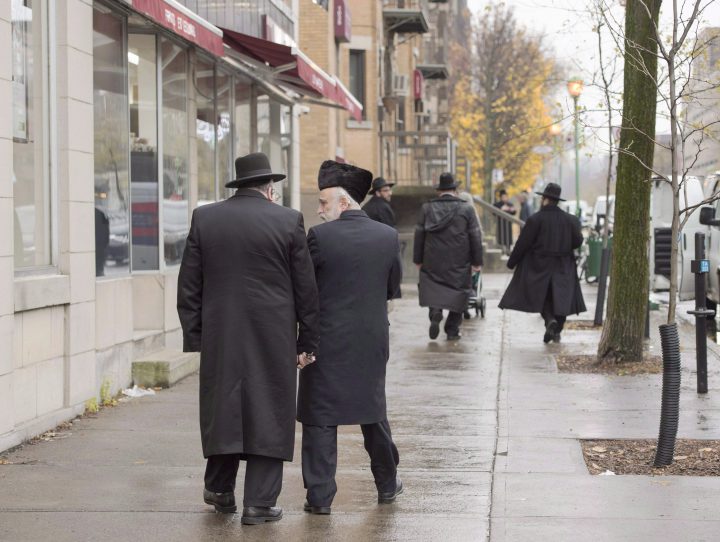 Hasidic Jewish men walk along Bernard Street in Outremont, in Montreal on Nov. 16, 2016. 
