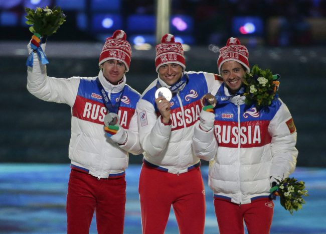 Russian athletes pose after completing a clean sweep of the podium at the men's 50K cross-country race event during the 2014 Winter Olympics in Sochi, Russia, Feb. 23, 2014.