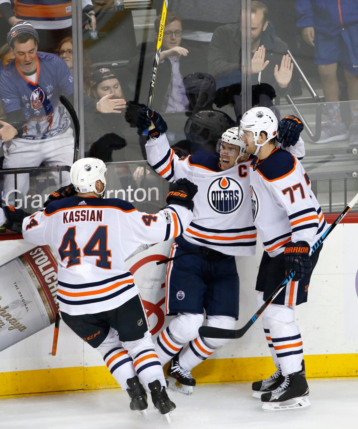 Edmonton Oilers right wing Zack Kassian (44) and Oilers defenseman Oscar Klefbom (77) of Sweden celebrate with Oilers center Connor McDavid (97) after McDavid scored the game-winning goal in overtime of an NHL hockey game against the New York Islanders in New York, Tuesday, Nov. 7, 2017. The final score was 2-1. 
