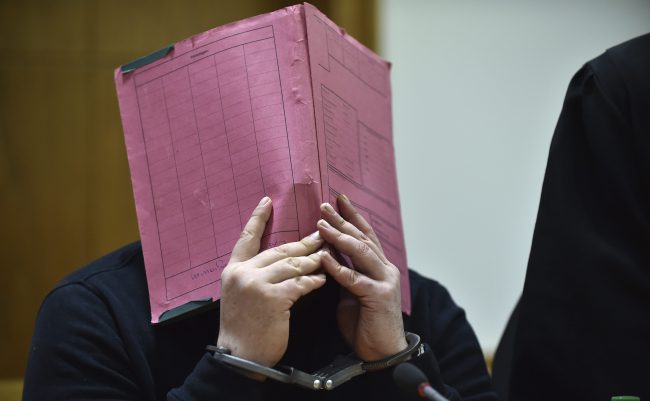 This Jan. 22, 2015 file photo shows former nurse Niels Hoegel covering his face during his trial at the regional court in in Oldenburg, northern Germany.