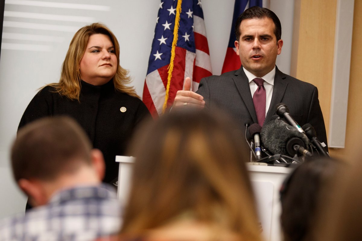Resident Commissioner Jenniffer Gonzalez-Colon, who represents Puerto Rico as a nonvoting member of Congress, listens as Puerto Rico Gov. Ricardo Rossello speaks during a news conference to urge Congress to include Puerto Rico in the Supplemental Disaster Relief Package, Monday, Nov. 13, 2017, in Washington.