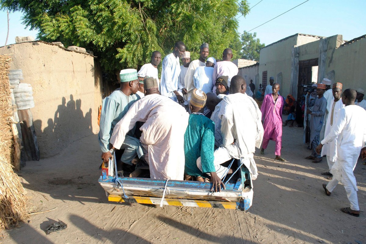 People transport a body of a suicide attack victim for funeral in Maiduguri, Nigeria on Thursday, November 16. 