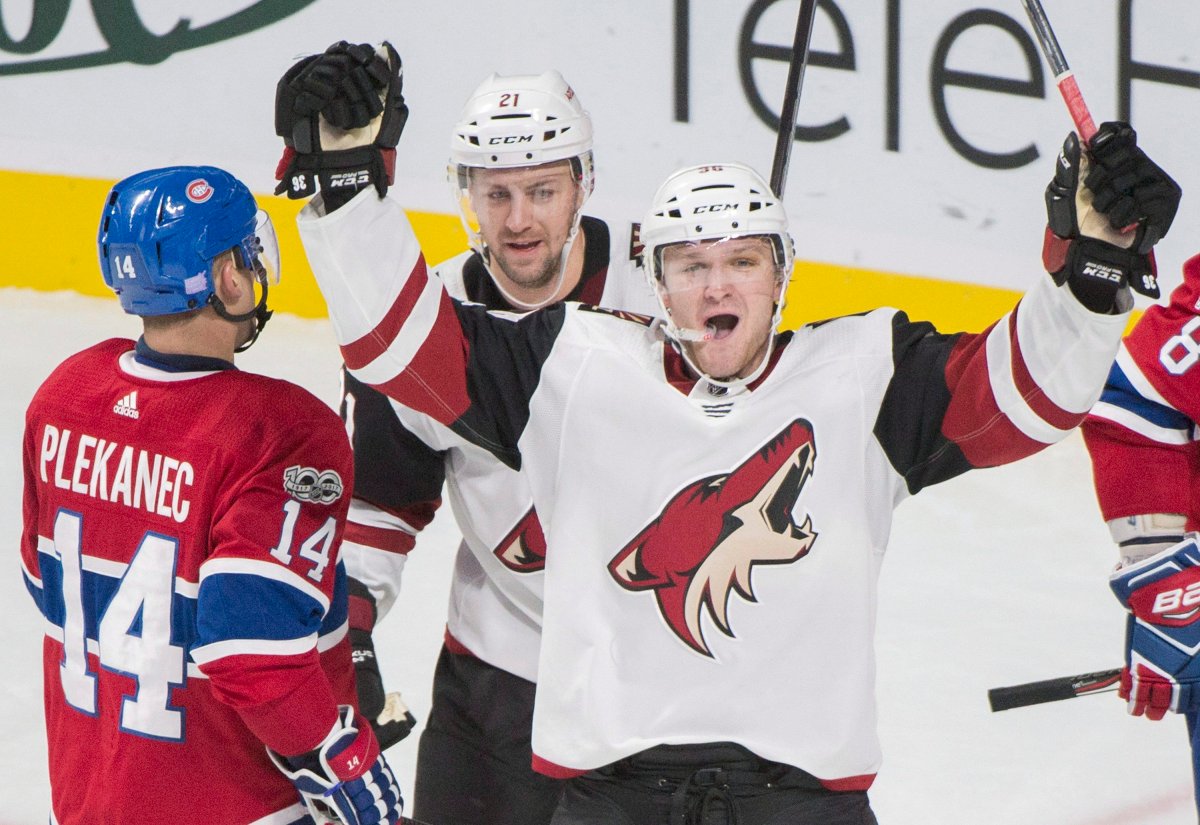 Arizona Coyotes' Christian Fischer celebrates with teammate Derek Stepan after scoring against the Montreal Canadiens.