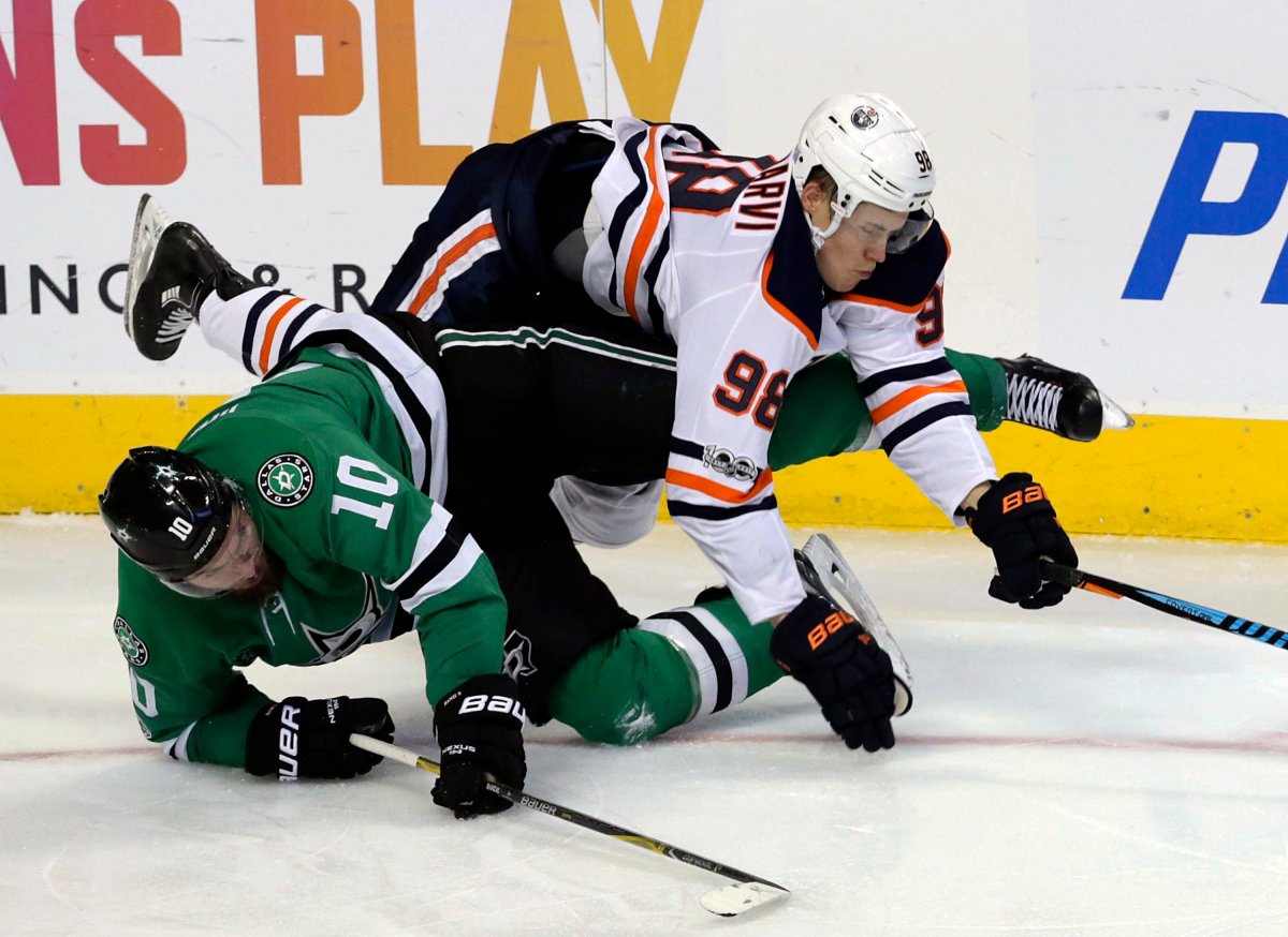 Dallas Stars centre Martin Hanzal (10) and Edmonton Oilers right wing Jesse Puljujarvi (98) fall to the ice during the third period of an NHL hockey game in Dallas, Saturday, Nov. 18, 2017. The Stars won 6-3. 