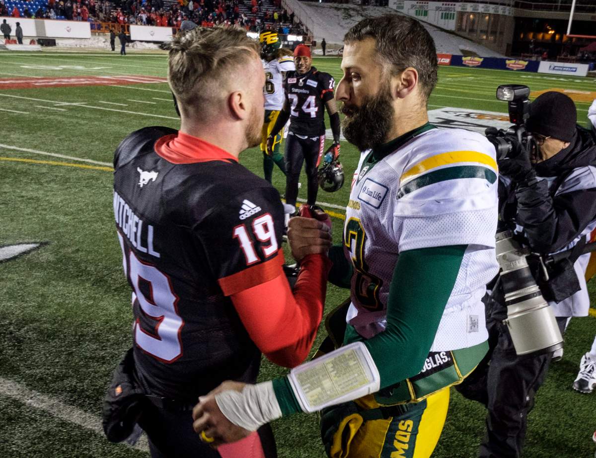 Edmonton Eskimos quarterback Mike Reilly, right, congratulates Calgary Stampeders quarterback Bo Levi Mitchell following the CFL West Final football game in Calgary, Sunday, Nov. 19, 2017.THE CANADIAN PRESS/Jeff McIntosh