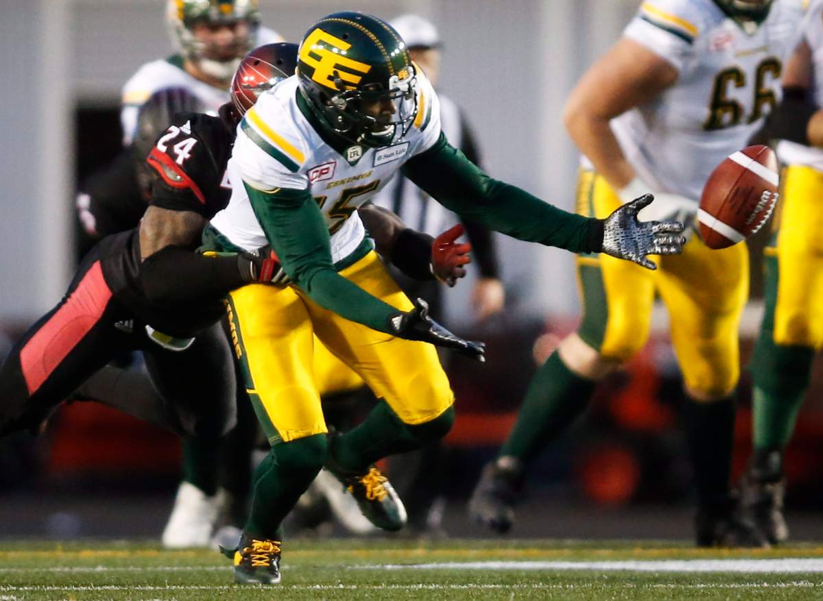Edmonton Eskimos’ Vidal Hazelton, right, reaches for a pass as Calgary Stampeders’ Joe Burnett tackles him during second half CFL West Final football action in Calgary, Sunday, Nov. 19, 2017.THE CANADIAN PRESS/Jeff McIntosh