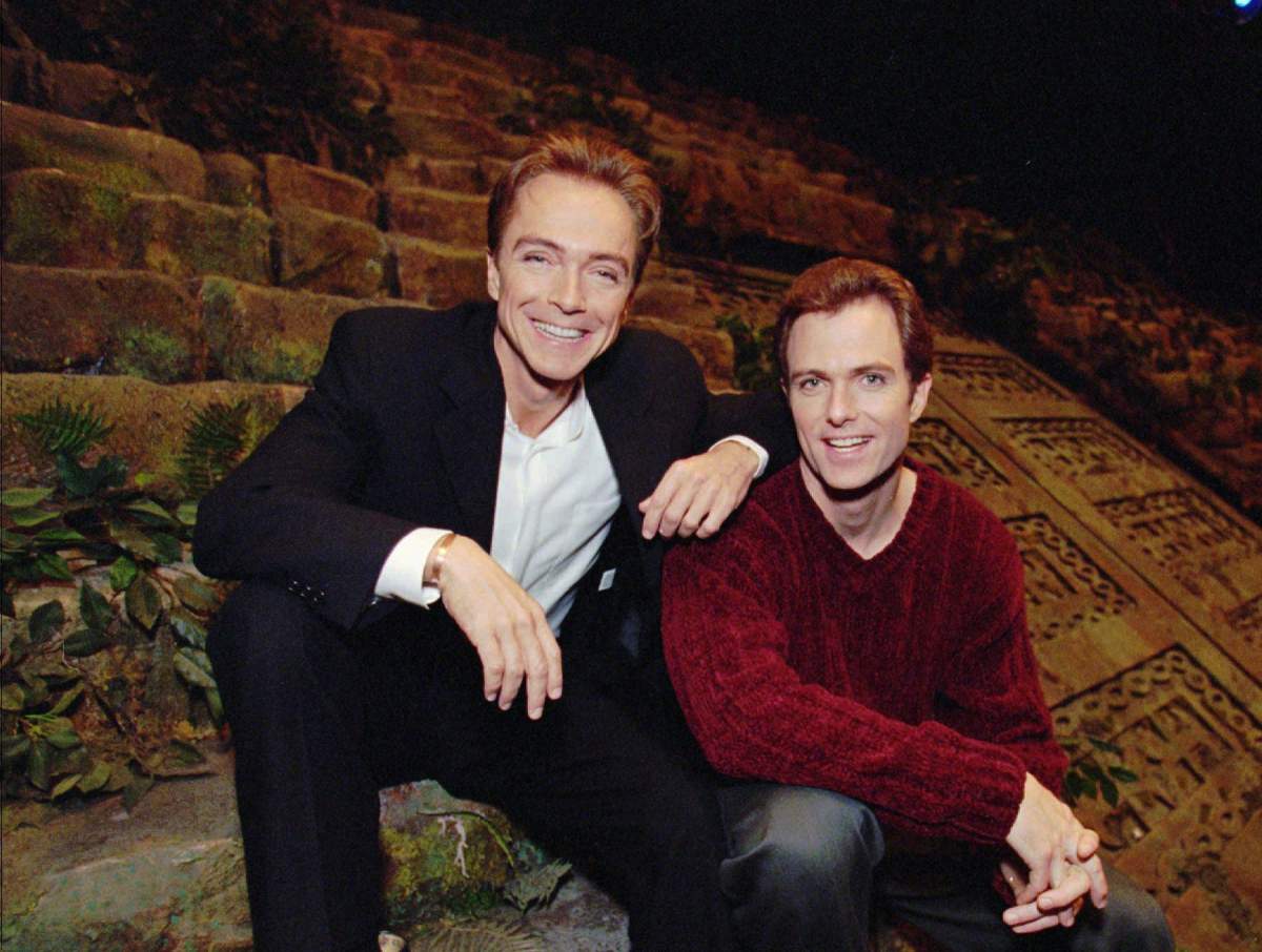 In this Nov. 11, 1997, file photo, David Cassidy, left, and brother Patrick sit on the stage of EFX at the MGM Grand in Las Vegas.
