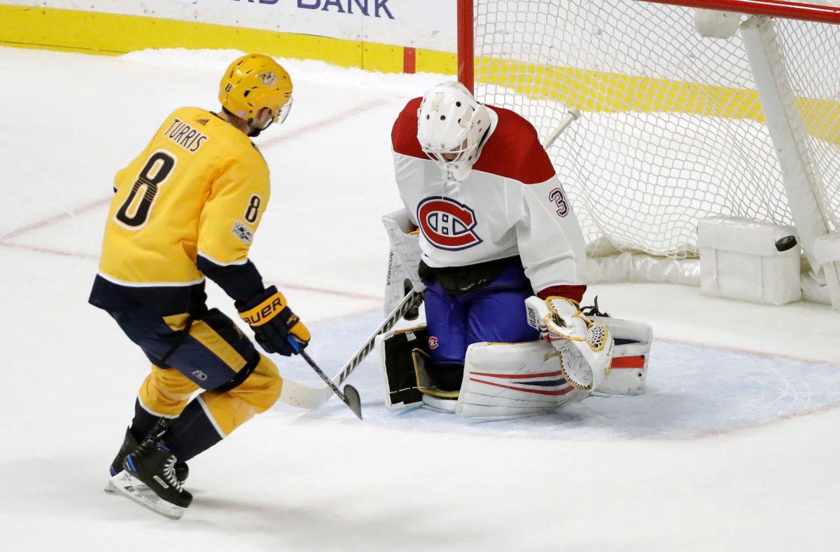 Nashville Predators center Kyle Turris scores the winning goal against Montreal Canadiens goalie Antti Niemi.