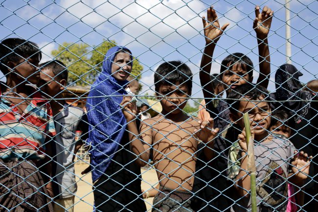 Rohngya refugees including children and women wait outside a fence of a health clinic at the Kutupalong, Coxabazar in Bangladesh 19 November 2017.  International politicians are currently on a fact finding tour to gather information about the Rohingya crisis, while Bangladesh hopes for international help and support for the refugees.  