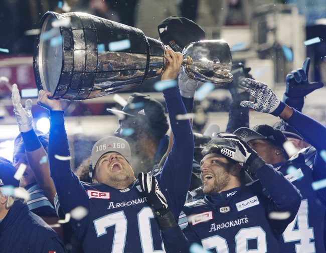 Toronto Argonauts kicker Lirim Hajrullahu (70) and Jimmy Ralph (88) celebrate with the Grey Cup after defeating the Calgary Stampeders in CFL football action in the 105th Grey Cup on Sunday, November 26, 2017 in Ottawa. 