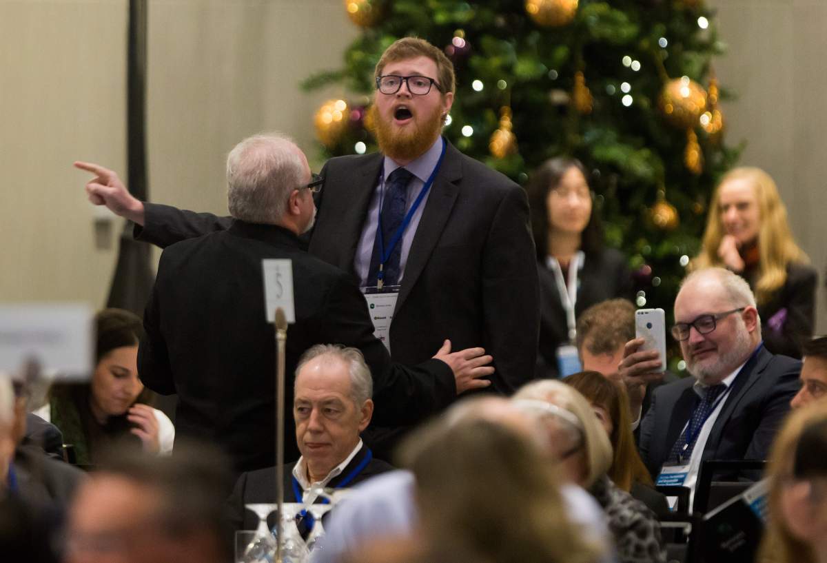 A protester interrupts an address by Federal Minister of Natural Resources Jim Carr during the Greater Vancouver Board of Trade's annual Energy Forum, in Vancouver on Thursday, November 30, 2017. 