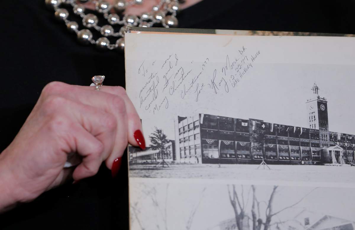 Beverly Nelson shows a school yearbook signed by Roy Moore during a news conference announcing new allegations of sexual misconduct against Alabama Republican congressional candidate Roy Moore.