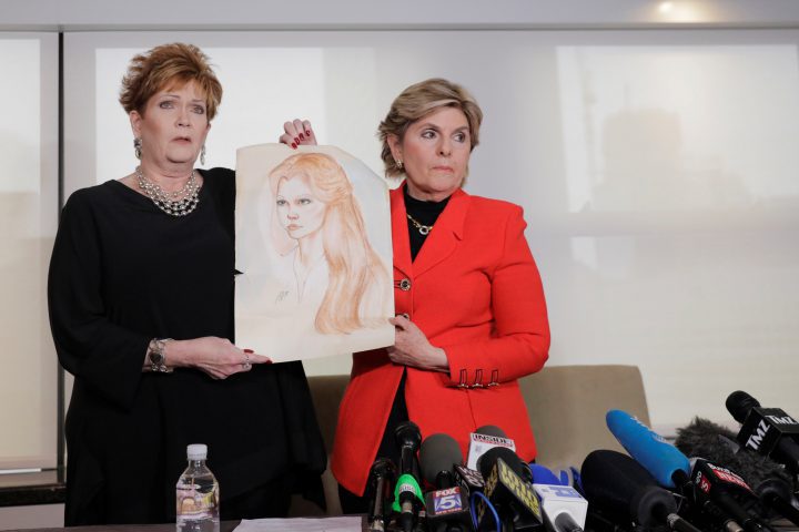 Attorney Gloria Allred stands with accuser Beverly Young Nelson, holding a sketch of herself made when she was 16, after reading a statement claiming that Alabama senate candidate Roy Moore sexually harassed her when she was 16, in New York, U.S., Nov. 13, 2017.