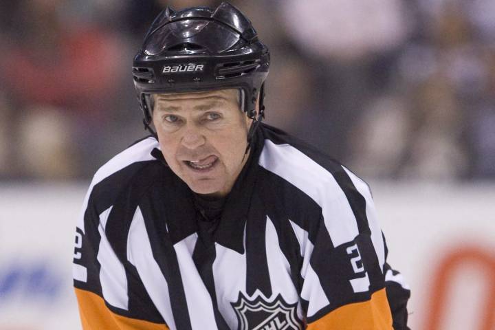 Referee Kerry Fraser watches the play during first period NHL hockey action between the Toronto Maple Leafs and the New York Rangers in Toronto Saturday, March 27, 2010. 