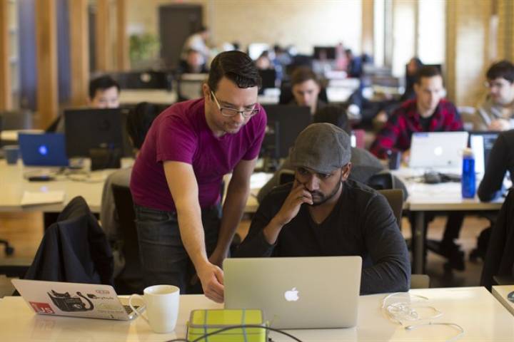 A tutor helps a student at Lighthouse Labs, which offers bootcamps on coding, in Toronto on Thursday, March 17, 2016.