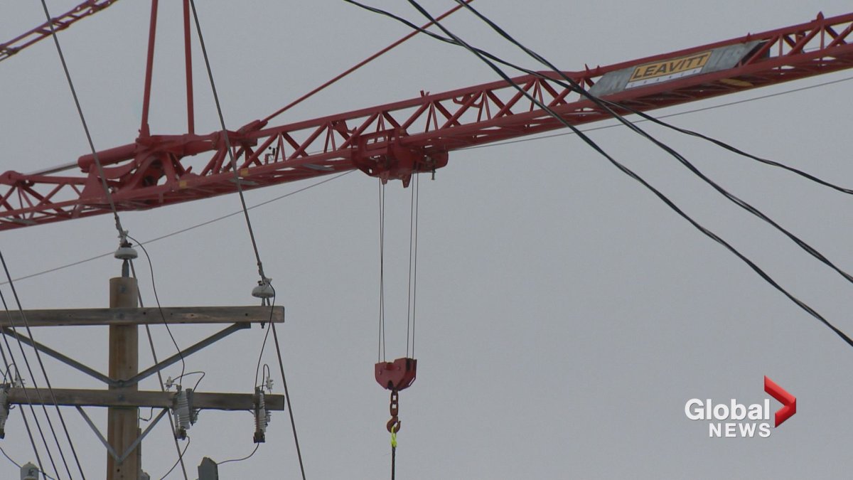 A construction crane that struck power lines caused power outages and traffic delays in northwest Calgary on Tuesday. 