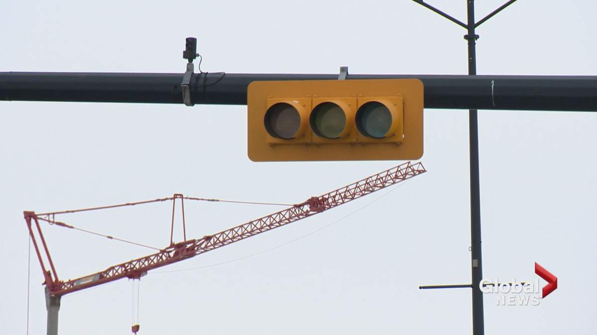 A construction crane that struck power lines caused power outages and traffic delays in northwest Calgary on Tuesday.