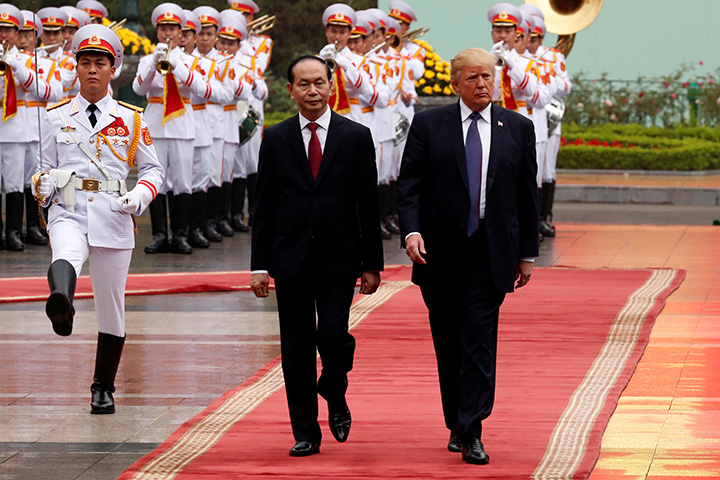 Vietnam's President Tran Dai Quang and U.S. President Donald Trump review troops before their bilateral meeting at the Presidential Palace in Hanoi, Vietnam November 12, 2017. 