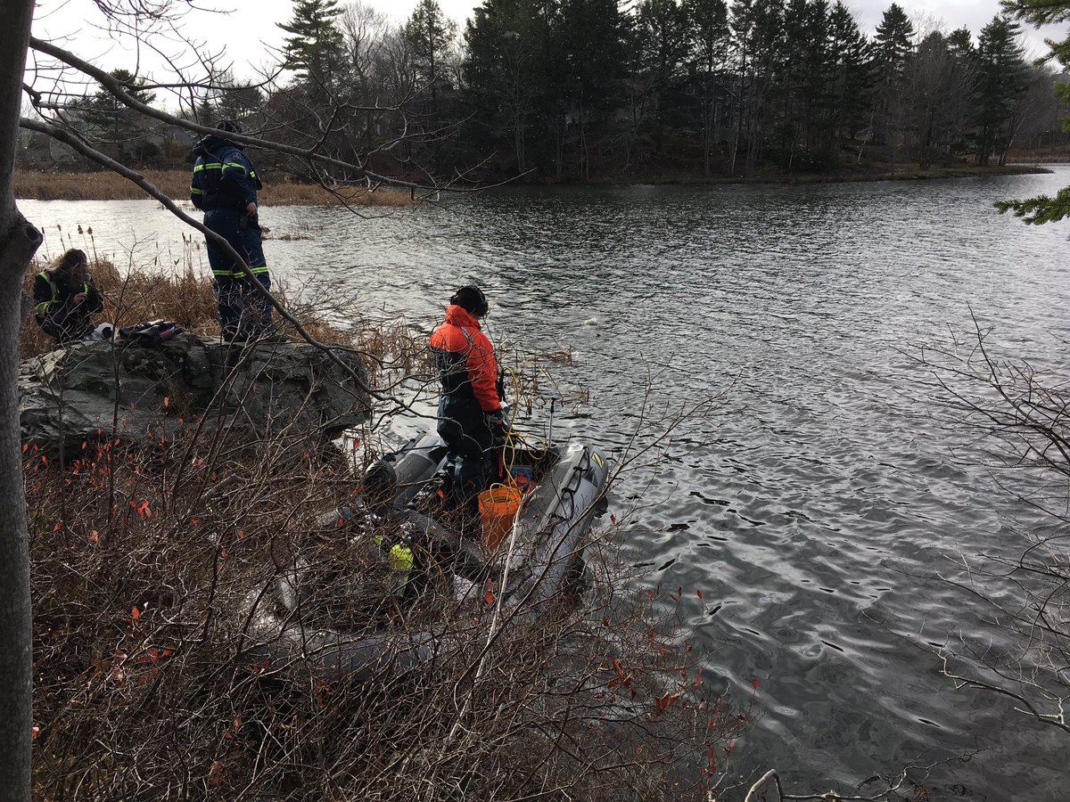 Members of the RCMP Underwater Recovery Team are searching the waters of Red Bridge Pond in Dartmouth for evidence related to the homicide of Tyler Richards.