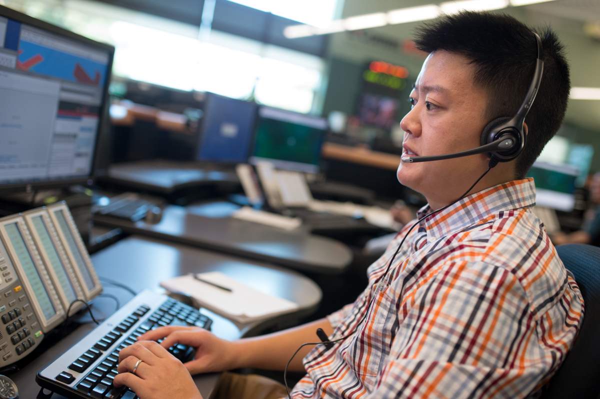 E-Comm's Jefferey Ching takes a call.