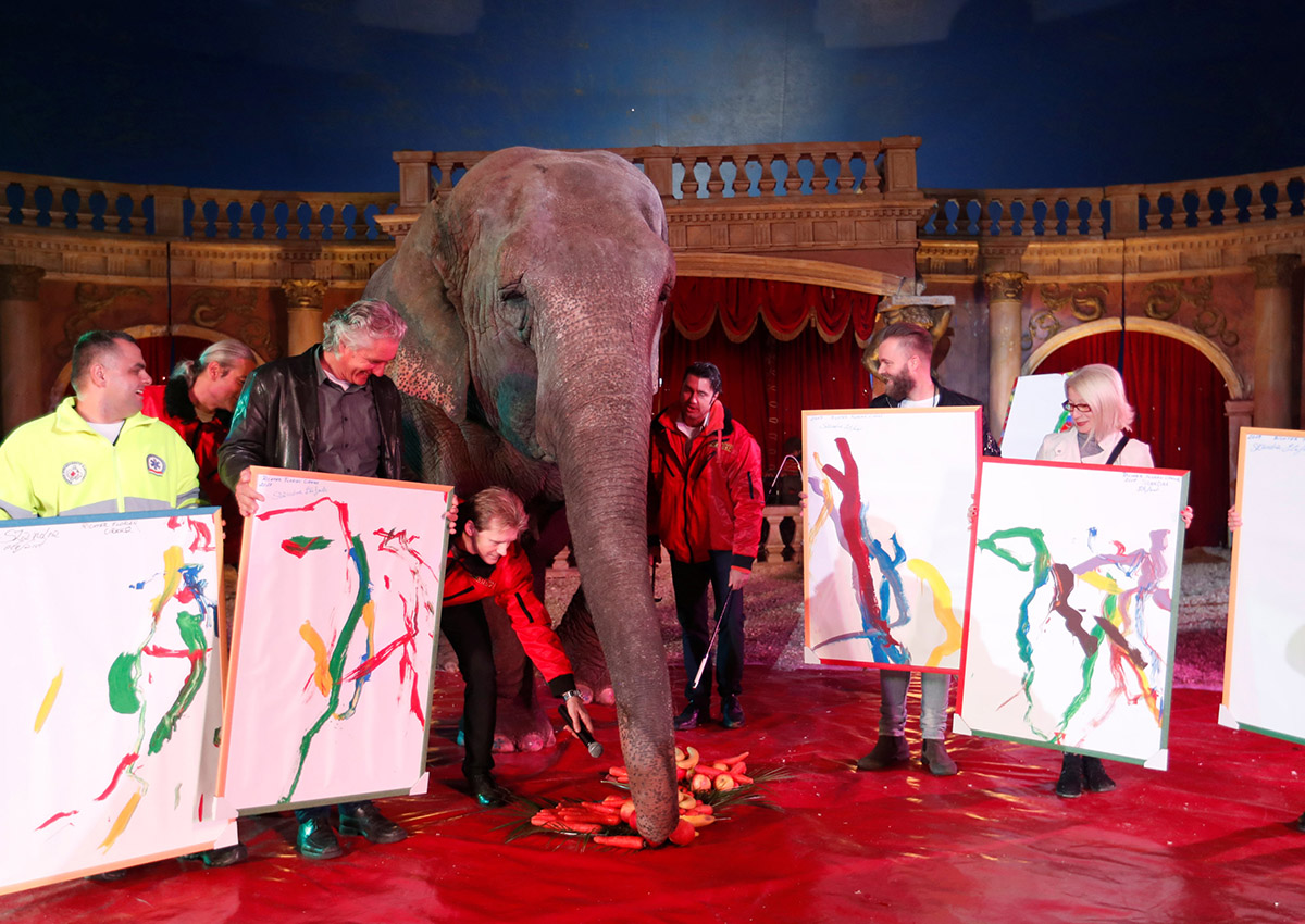 Sandra, a 42-year-old elephant, poses for a photo with Hungarian circus fans who bought her painting in the Florian Richter Circus in Budapest, Hungary November 4, 2017.
