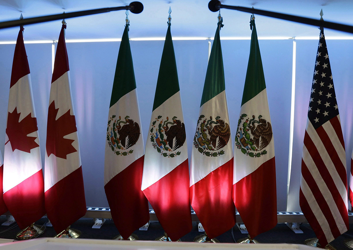 National flags representing Canada, Mexico, and the U.S. are lit by stage lights at the North American Free Trade Agreement, NAFTA, renegotiations, in Mexico City, on September 5, 2017. 