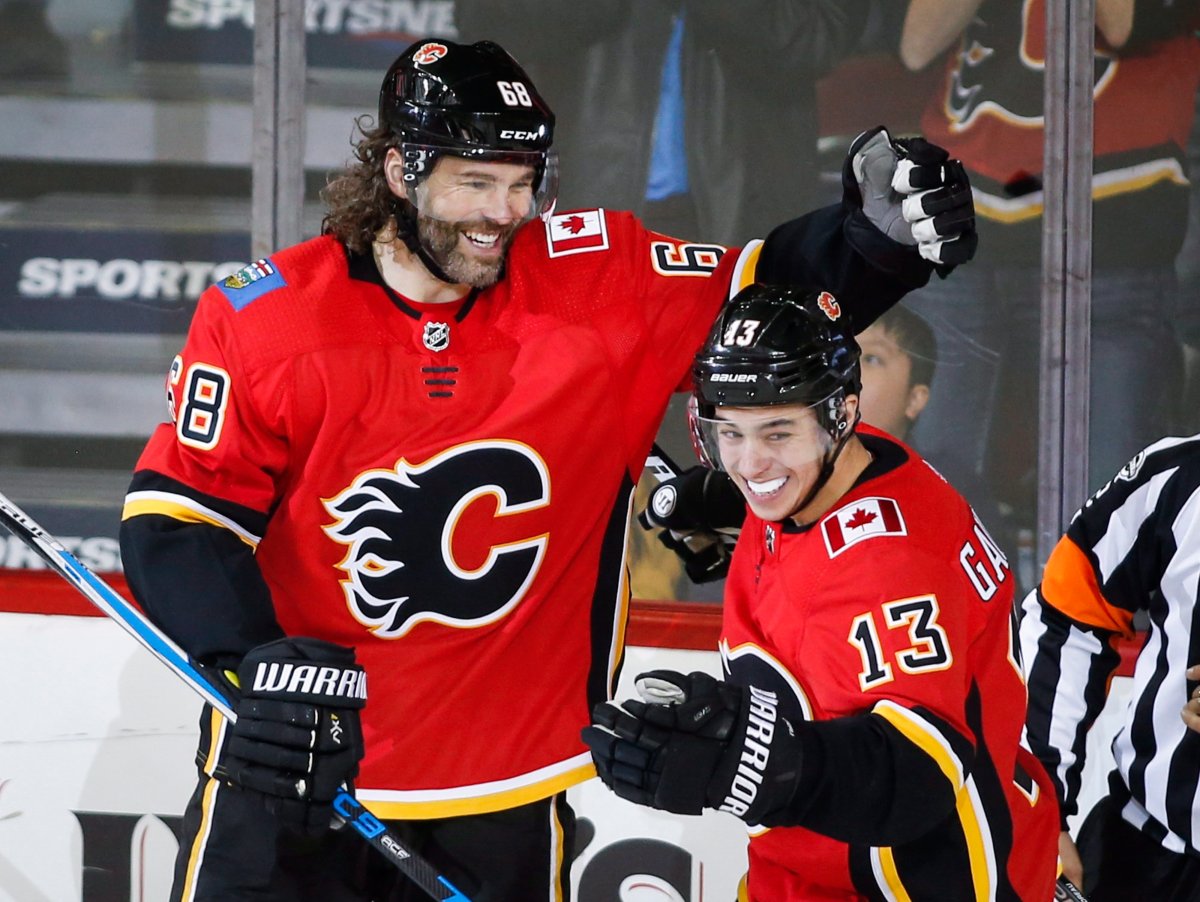 Calgary Flames' Jaromir Jagr, left, of the Czech Republic, celebrates his first goal as a Calgary Flame with teammate Johnny Gaudreau during second period NHL hockey action against the Detroit Red Wings, in Calgary on Thursday, Nov. 9, 2017. THE CANADIAN PRESS/Jeff McIntosh.