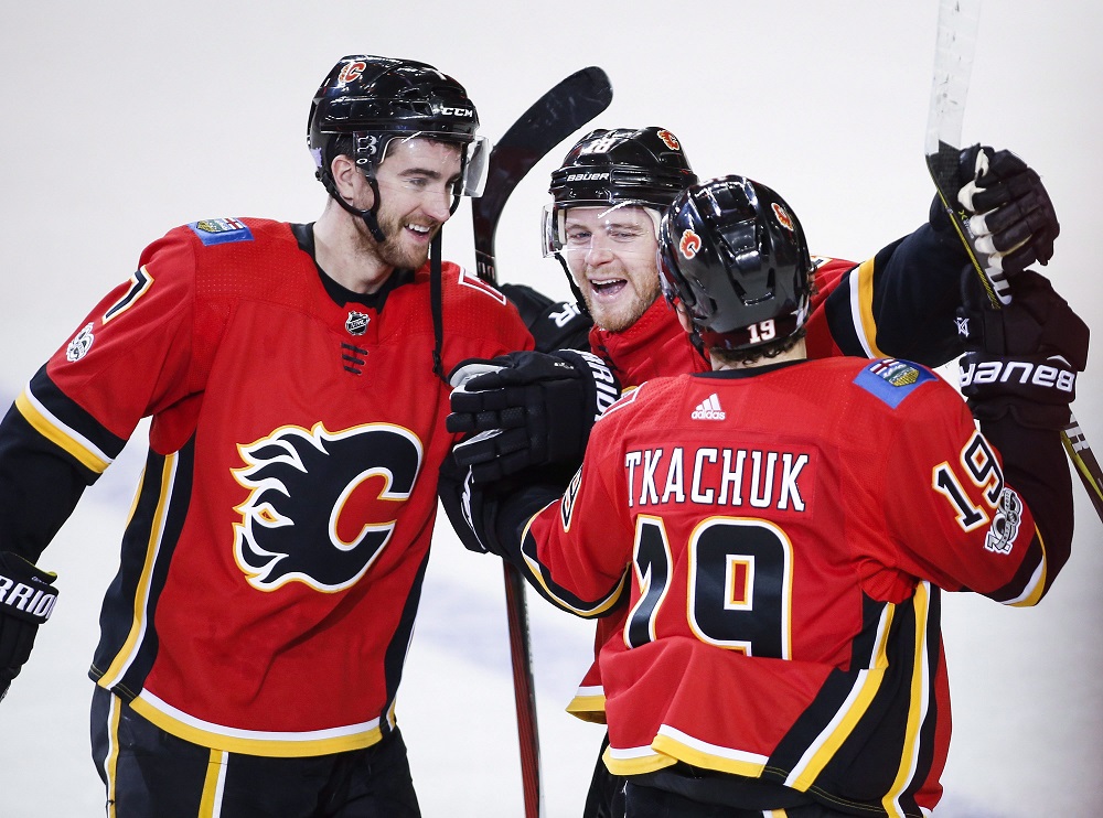 Calgary Flames' Matthew Tkachuk, right, celebrates his game-wiinning shootout goal with teammates Matt Stajan, centre, and T.J. Brodie during overtime NHL hockey action against the New Jersey Devils in Calgary, Sunday, Nov. 5, 2017.THE CANADIAN PRESS/Jeff McIntosh.
