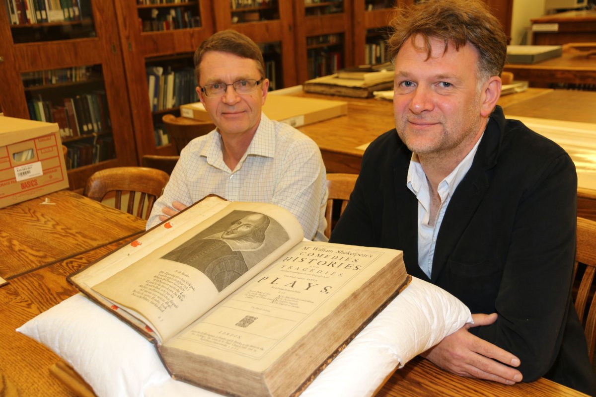 Archivist Robin Keirstead and Shakespearean scholar Prof. James Purkis of the Department of English, examine the newly donated Shakespeare's Fourth Folio (1685) at Western Libraries Archives and Special Collections.