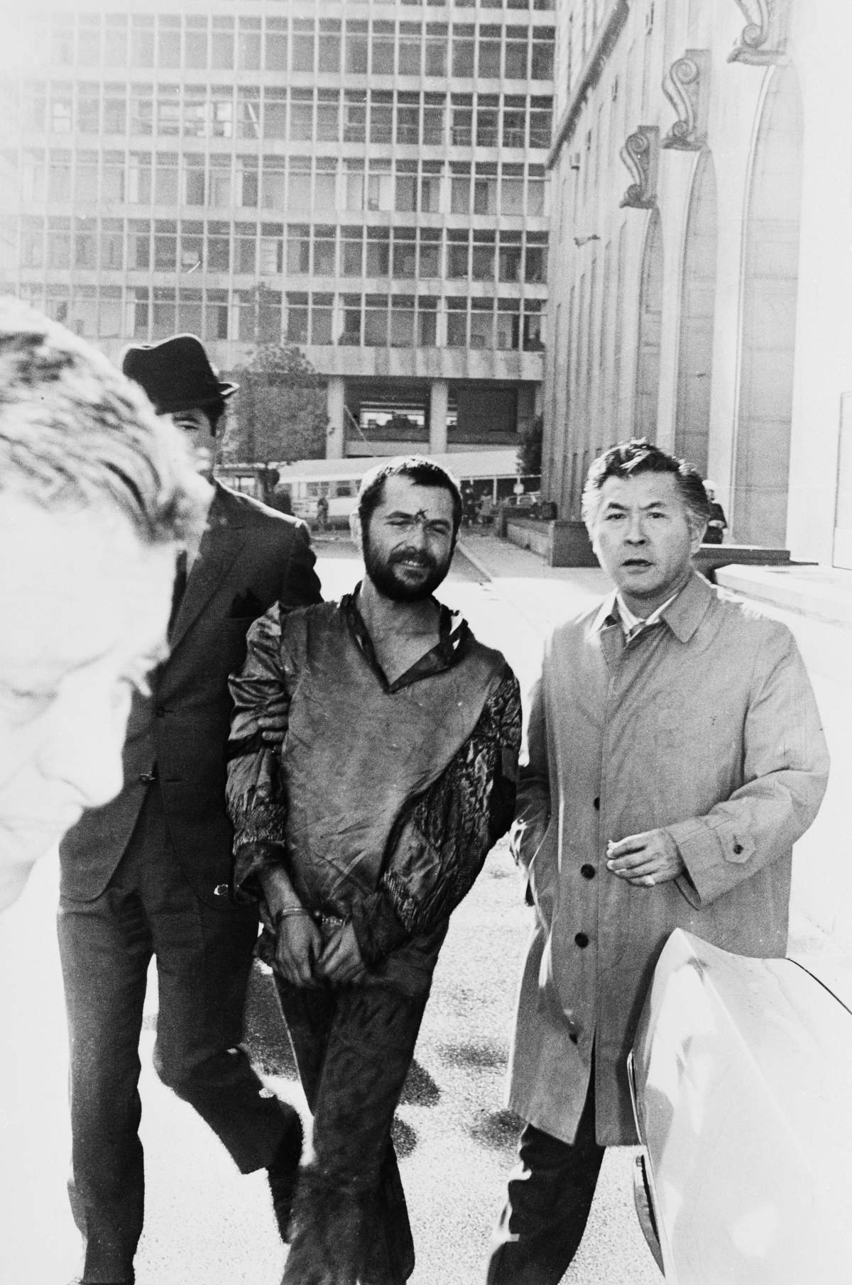 Bruce Davis, the Manson Family “X” carved in his forehead, walks with his attorney Daye Shinn (right) after he surrendered himself to authorities outside the Hall of Justice. Davis is under indictment by the Grand Jury for the 1969 murder of Gary Hinman.