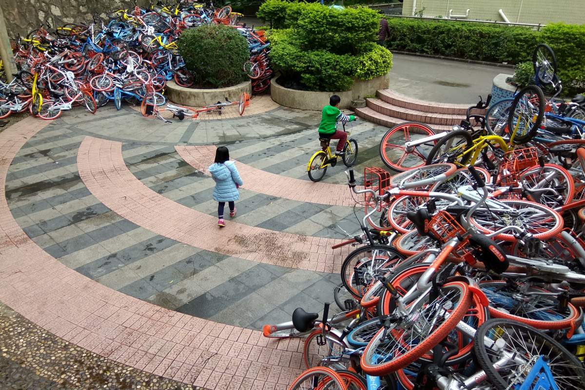 This picture taken on Jan. 16, 2017, shows rented bicycles from bike-sharing firms near the entrance of Xiashan park in Shenzhen, Guangdong province. (STR/AFP/Getty Images)