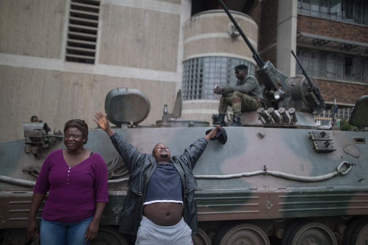 People gesture and shout slogans during a demonstration demanding the resignation of Zimbabwe’s president on November 19, 2017 in Harare. (Photo by Belal Khaled/NurPhoto via Getty Images)
