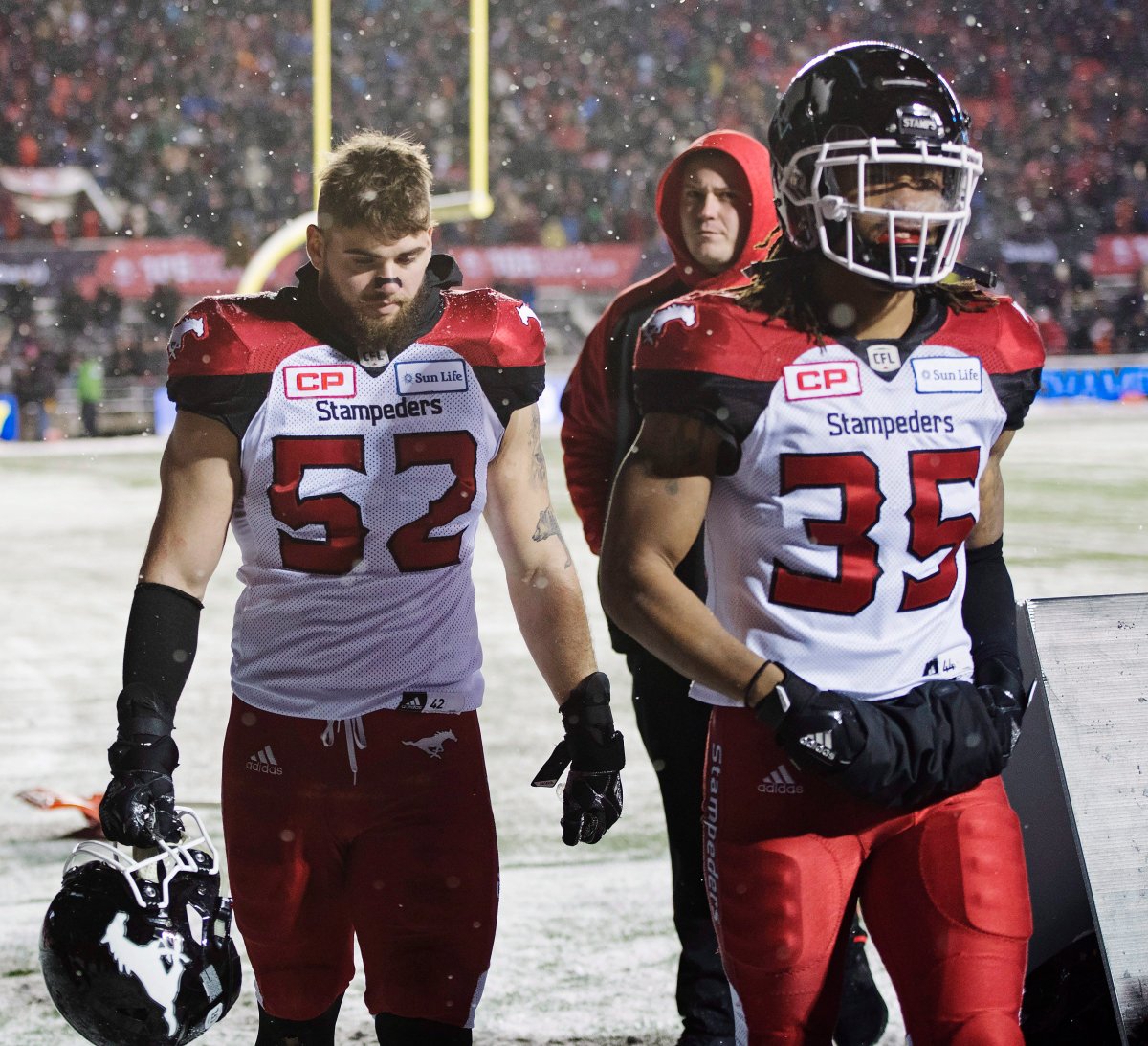 Calgary Stampeders linebacker Riley Jones, left, and Shaquille Richardson walk off the field after being defeated by the Toronto Argonauts in CFL football action in the 105th Grey Cup on Sunday, November 26, 2017 in Ottawa. THE CANADIAN PRESS/Justin Tang.