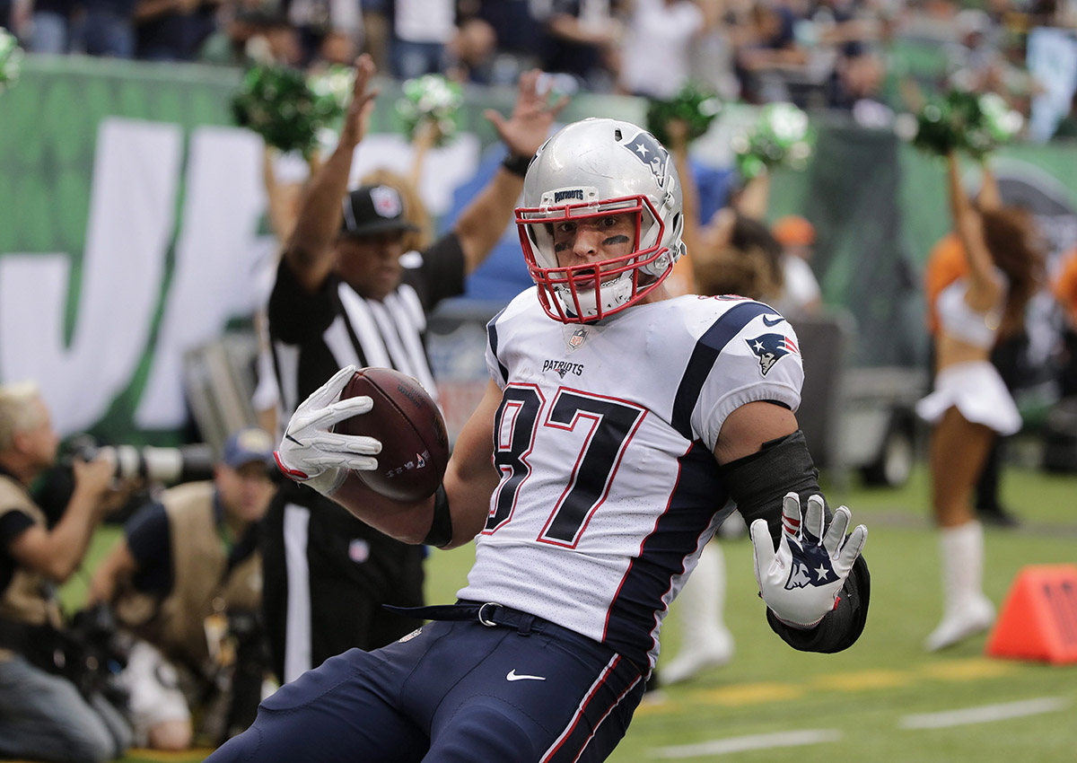New England Patriots' Rob Gronkowski (87) runs away from New York Jets' Marcus Maye for a touchdown during the second half of an NFL football game, Sunday, Oct. 15, 2017, in East Rutherford, N.J. (.