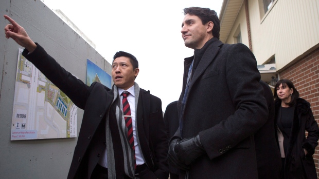 Prime Minister Justin Trudeau (right) stands with Jason Chen, Development Director at Toronto Community Housing as he visits a housing development in Toronto's Lawrence Heights neighbourhood ahead of a policy announcement, on Wednesday November 22, 2017. 