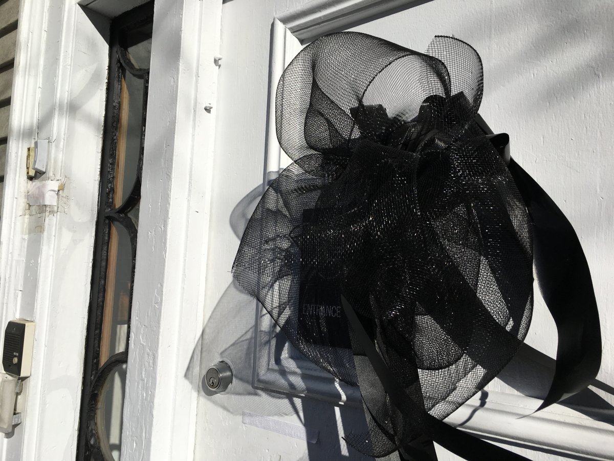 A black ribbon commemorating the 100th anniversary of the Halifax Explosion hangs on the door of Veith House.