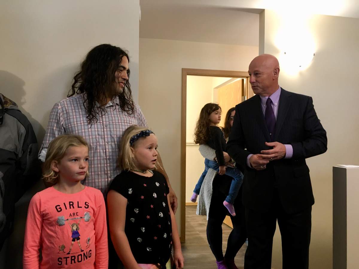 Todd, Chloe and Carmin received the keys to their new home from Sandy Hopkins, president of the Manitoba Habitat team, Monday. 