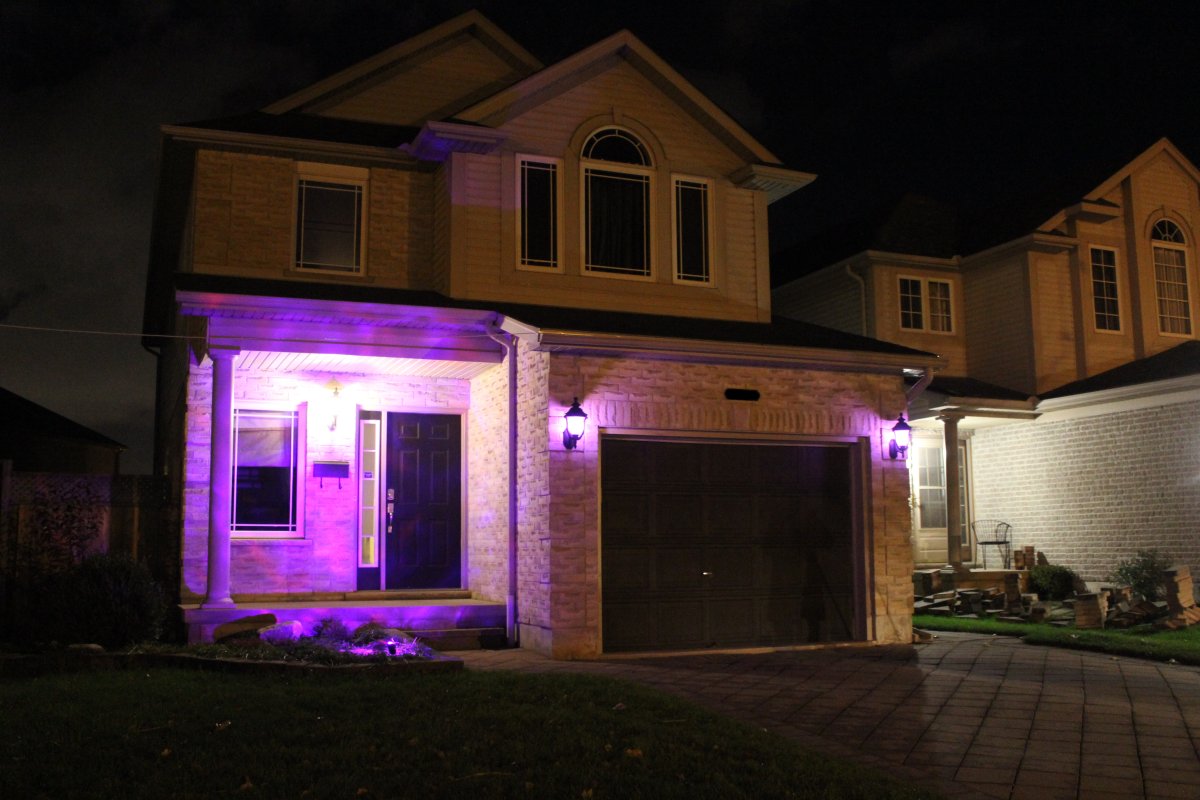 A flood light and two garage lights bathe this Summerside home in a purple glow. 