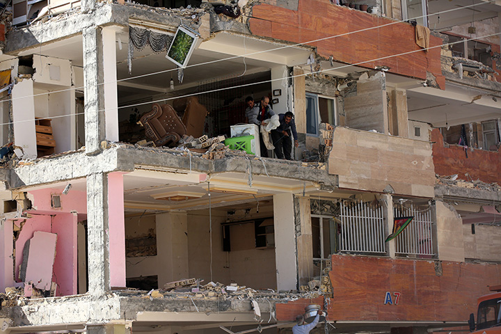 People collect belongings in heavily damaged buildings in Sarpol-e Zahab town of Kermanshah, Iran on November 14, 2017 following a 7.3 magnitude earthquake.