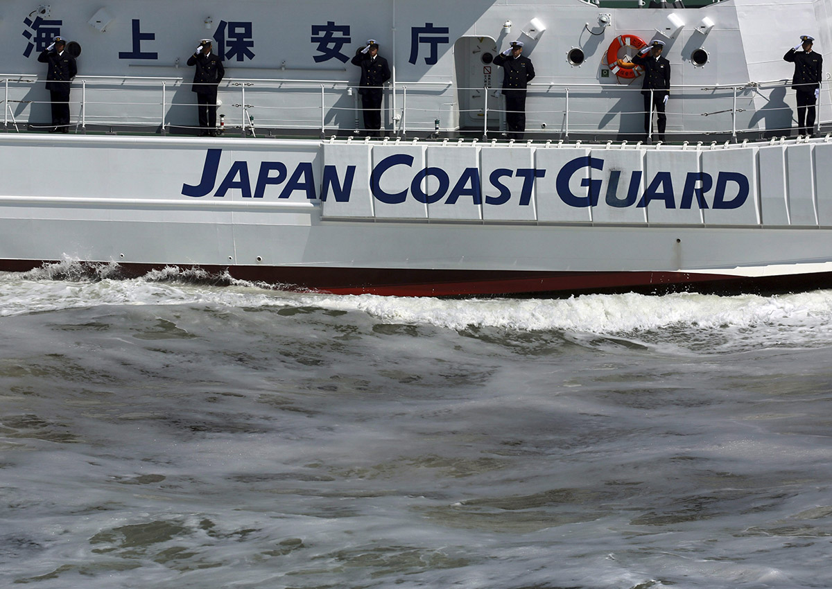 Members of Japan Coast Guard salute from a ship during an exercise in Tokyo Bay Saturday, May 20, 2017, in Tokyo. Japan Coast Guard conducted an annual review of their fleet and drills.