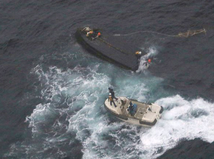 Japanese coast guard vessel approaches capsized boat