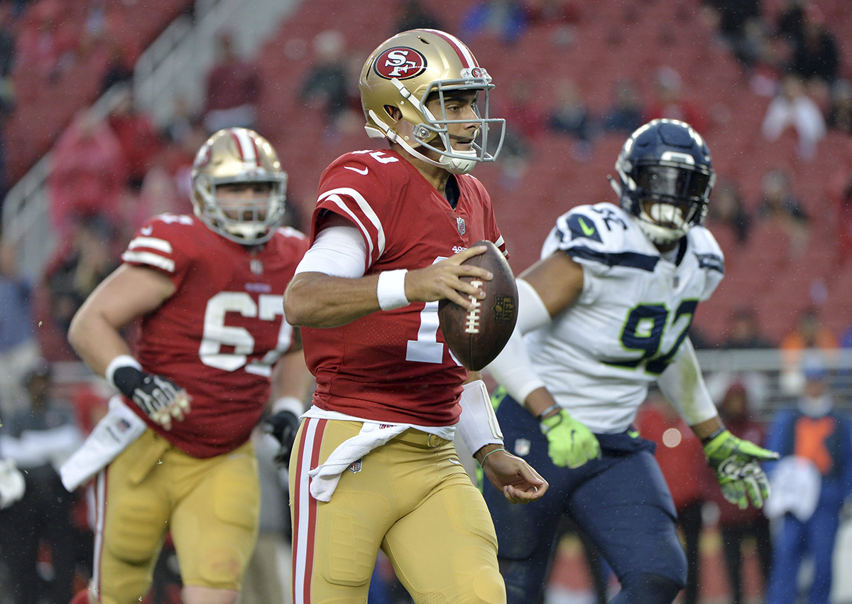 San Francisco 49ers quarterback Jimmy Garoppolo (10) runs against the Seattle Seahawks during the second half of an NFL football game Sunday, Nov. 26, 2017, in Santa Clara, Calif. 