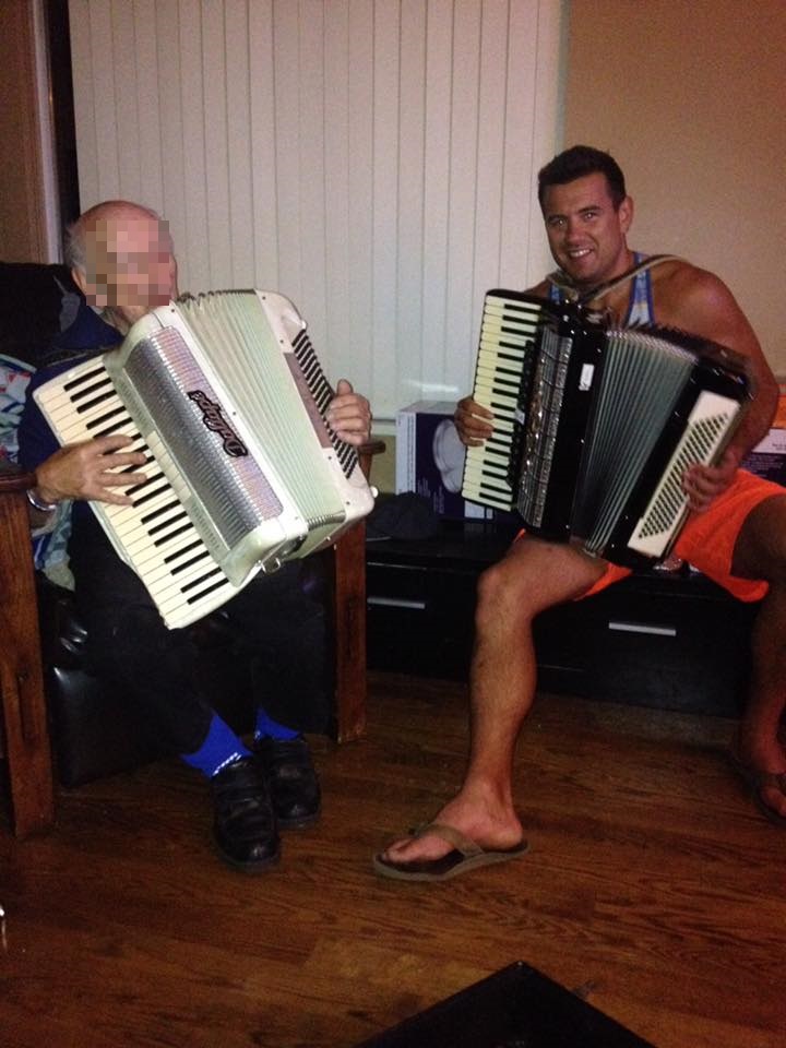 Lucas William Robert Robinson (right) playing the accordion with his elder relative.