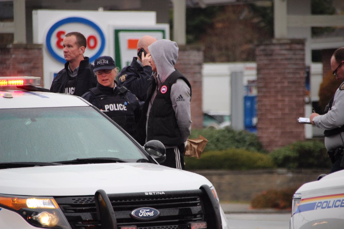 One of two suspects being taken into custody in Langley following an alleged road rage incident. The pair have now been charged for multiple firearms offences.