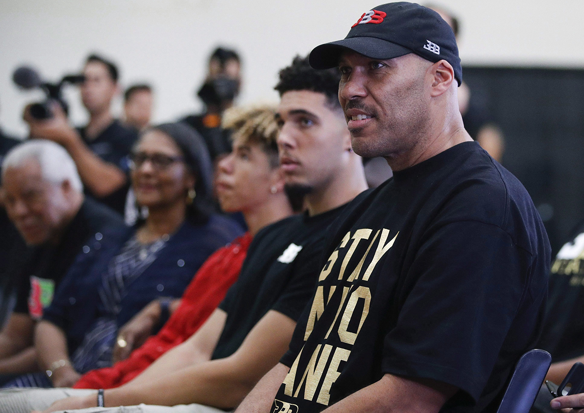 In this June 23, 2017, file photo, LaVar Ball, right, father of Los Angeles Lakers draft pick Lonzo Ball, listens to his son during the NBA basketball team's news conference in El Segundo, Calif.