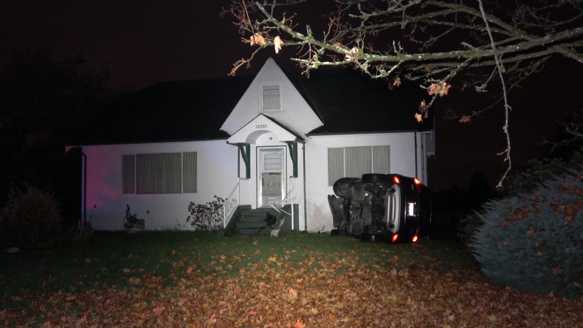 The crashed car on the front lawn of the Maple Ridge home.