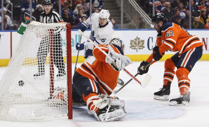 Toronto Maple Leafs' Matt Martin (15) scores a goal on Edmonton Oilers goalie Laurent Brossoit (1) as Eric Gryba (62) defends during first period NHL action in Edmonton, Alta., on Thursday November 30, 2017. 