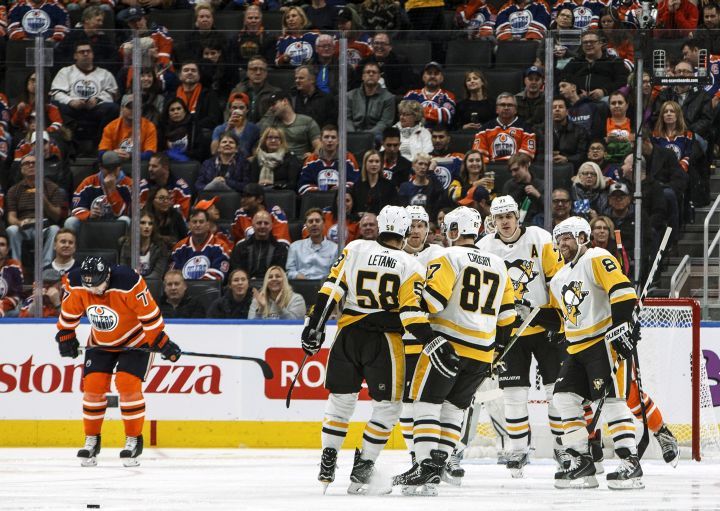 Pittsburgh Penguins players celebrate a goal as Edmonton Oilers' Oscar Klefbom (77) reacts during second period NHL action in Edmonton, Alta., on Wednesday November 1, 2017. 