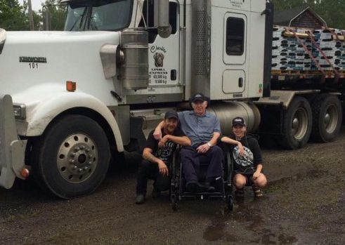 Robert Price with his father Dougie Price and daughter Karissa Price in front of the rig he lost when a hijacker tried to escape police and rolled it off the highway near Kamloops. 